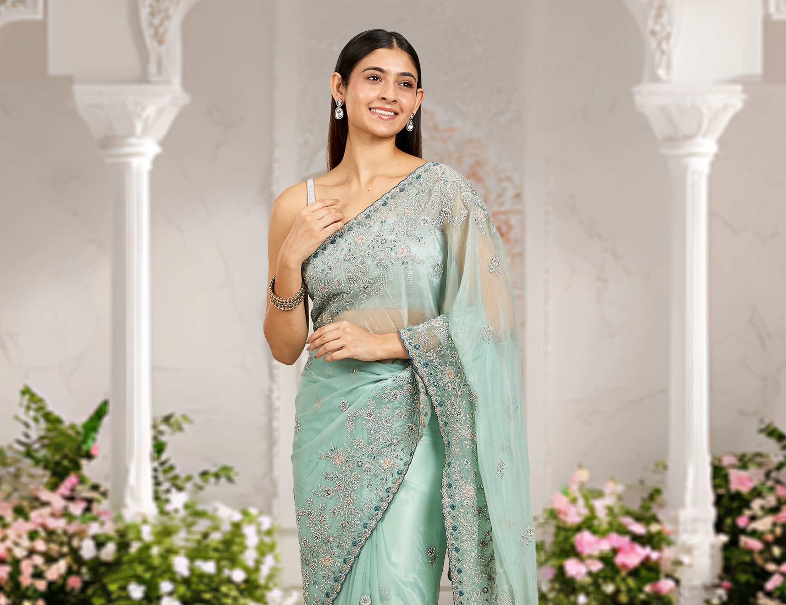 Women wearing elegant green mirror work saree 